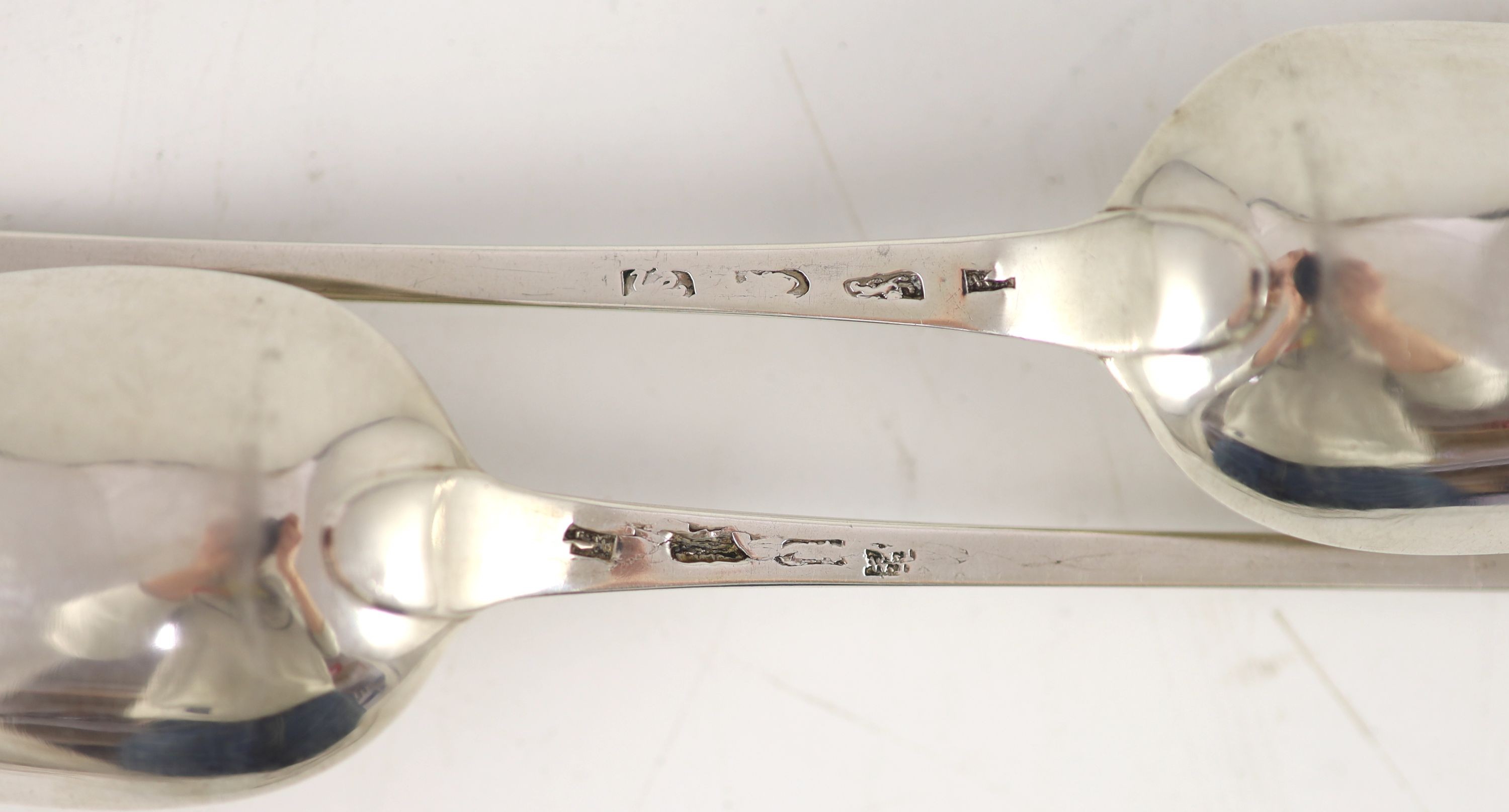 A pair of George III silver feather edge Old English pattern straining spoons, marks pinched
